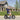 Man riding Hiboy U2 Pro Electric Scooter with fat tires on a sunny day in a suburban neighborhood for a comfortable commute.