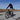 Rider on Hiboy P7 E-Bike, showcasing its sleek design on an open road with blue skies.