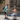 A woman on the Inmotion E20 electric unicycle interacts with a man and their dog outdoors.