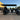 TrailMaster TBM X6 6-seater electric golf cart with foldable windshield, 22” rims, and LED lights parked outdoors.