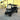 TrailMaster TBM X6 electric golf cart with foldable windshield and carbon fiber steering wheel, parked outside a building.