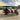TrailMaster TBM X6 6-seater electric golf cart with red exterior, foldable windshield, aluminum rims, and LED headlights.