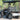 TrailMaster Taurus 50EV electric golf cart with aluminum wheels, 60V motor, and DOT light package on a sunny day.