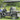 TrailMaster Taurus 50EV 4-seat electric golf cart with aluminum wheels, off-road tires, and DOT light package in a grassy area.
