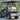 TrailMaster Taurus 50EV 4-Seat Electric Golf Cart with DOT Light Package, aluminum wheels, and off-road tires on paved road.