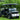 TrailMaster Taurus 80ED-GV 6-seat electric golf cart with extended roof, parked outdoors in a grassy area, showcasing rear-facing seats.