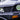 Close-up of TrailMaster Taurus 80ED-U 4-seat electric golf cart's front grille and LED headlights, showcasing modern design.
