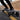 Rider on a B-ONE Balrog X electric skateboard on a gravel path, showcasing its all-terrain capabilities.