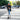 A woman in a casual outfit riding a Hiboy S2 electric scooter on a city street.