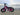 AR Atom 1000 Watt Mini Electric Bicycle in vibrant pink parked by the waterfront, showcasing its robust design.