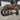 AR Atom 1000W Mini Electric Bicycle in orange with thick tires, outdoor setting, showcasing robust design.