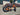 AR Atom 1000W Mini Electric Bicycle in orange with thick tires, outdoor setting, showcasing robust design.