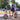 Young man using smartphone while sitting on Hiboy ECOM 14 eco-friendly fat tire electric scooter in urban park.