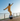 Rider practicing balance on the Inmotion E20 dual wheel electric unicycle in a sunny outdoor setting.