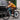 Man riding a Rundeer Starry Sky Carbon Fiber Electric Bike on an urban street.