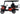 Red TrailMaster TBM X4 electric golf cart with 5kW lithium battery, foldable windshield, carbon fiber wheel, LED lights, and 22” rims.
