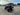 Red TrailMaster TBM X6 6-seater electric golf cart with 22” aluminum rims and foldable windshield in an outdoor parking area.