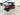 TrailMaster TBM X6 red electric golf cart, 6 seats, 48-mile range, 5kW lithium battery, 22” aluminum rims, LED headlights