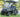 TrailMaster Taurus 50EV electric golf cart with DOT light package, aluminum wheels, off-road tires, and digital dashboard.