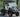 TrailMaster Taurus 50EV Electric Golf Cart with DOT lights, aluminum wheels, and rugged off-road tires in a natural setting.