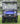 TrailMaster Taurus 50EV electric golf cart with 60V motor, full DOT light package, and off-road tires on grass.