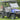 TrailMaster Taurus 50EV 4-seat electric golf cart in blue, featuring 60V motor, off-road tires, and LED headlights, on green grass.
