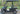 TrailMaster Taurus 50EV electric golf cart with aluminum wheels, off-road tires, and full DOT light package, parked outdoors.