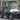 TrailMaster Taurus 50EV 4-seat electric golf cart with off-road tires, LED headlights, and rearview mirrors, parked outdoors.
