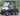TrailMaster Taurus 50EV 4-seat electric golf cart with 60V motor and DOT light package, aluminum wheels, and off-road tires.