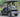 TrailMaster Taurus 50EV electric golf cart with aluminum wheels and off-road tires, 60V motor, side mirrors, and LED headlights.