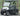 TrailMaster Taurus 50EV 4-seat electric golf cart with DOT light package, aluminum wheels, and off-road tires on a road.