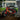 Red AR Atom 1000 Watt Mini Electric Bicycle parked by a tree, showcasing its sturdy frame and off-road tires.