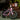 Pink Alien 2D2S mini electric bike with basket parked outside a café, showcasing its robust design and stylish look.